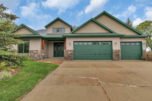 1108 Oak Pond Dr, Sartell, MN 56377 - craftsman-style house with stone siding, an attached garage, driveway, and a front lawn