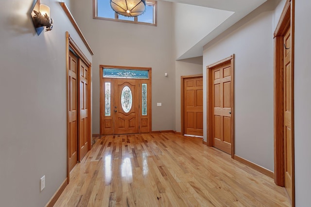 1108 Oak Pond Dr, Sartell, MN 56377 - entrance foyer featuring light wood finished floors, a towering ceiling, and baseboards