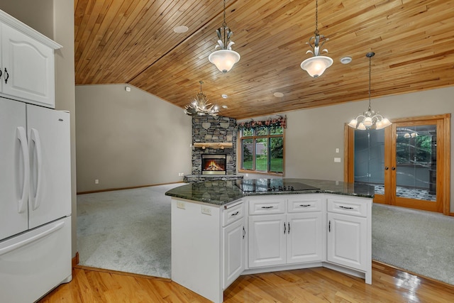 1108 Oak Pond Dr, Sartell, MN 56377 - kitchen with freestanding refrigerator, a chandelier, black electric stovetop, wood ceiling, and vaulted ceiling
