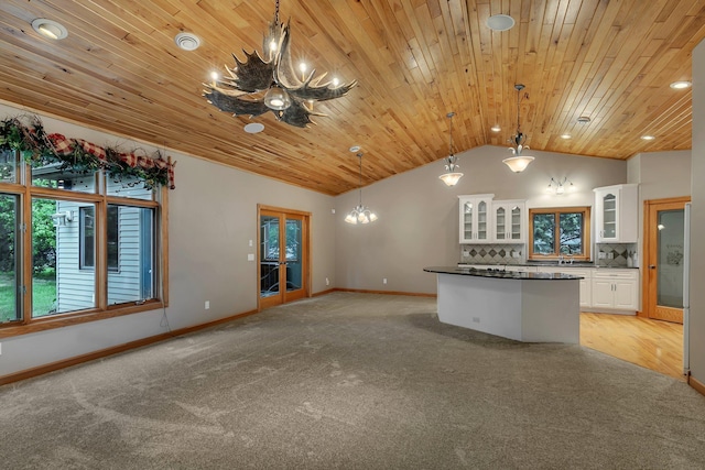 1108 Oak Pond Dr, Sartell, MN 56377 - unfurnished living room with a chandelier, lofted ceiling, light colored carpet, wood ceiling, and a sink