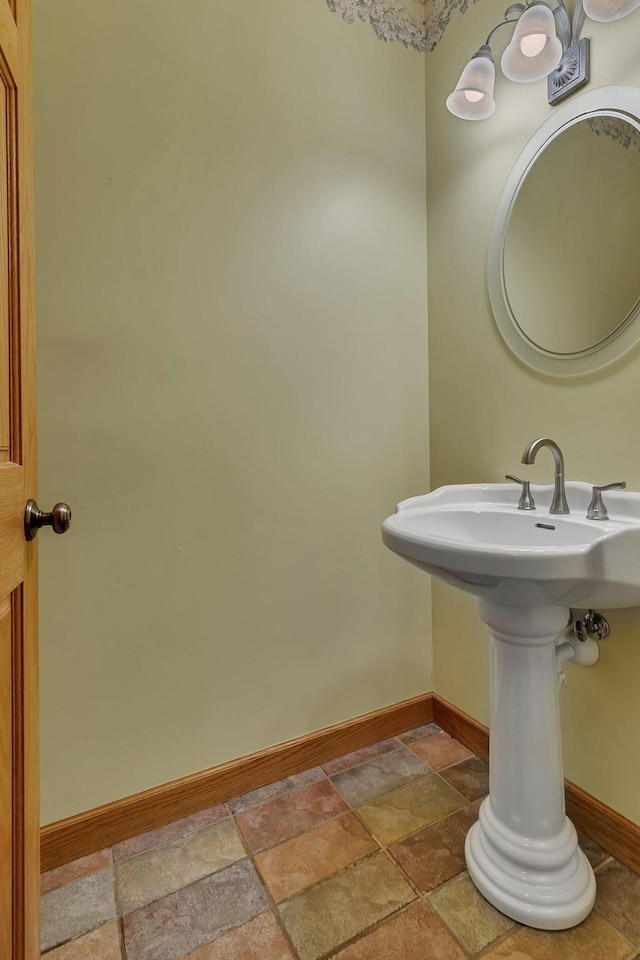 1108 Oak Pond Dr, Sartell, MN 56377 - bathroom featuring baseboards and stone tile flooring