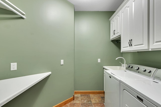 1108 Oak Pond Dr, Sartell, MN 56377 - laundry area featuring washing machine and dryer, cabinet space, baseboards, and stone finish flooring
