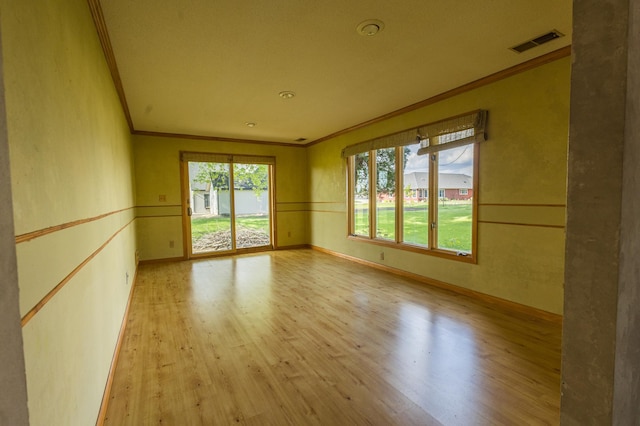 500 Lincoln St, Adams, MN 55909 - unfurnished room featuring crown molding, wood finished floors, and baseboards
