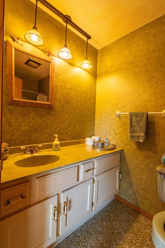 500 Lincoln St, Adams, MN 55909 - bathroom featuring a textured ceiling, toilet, and vanity