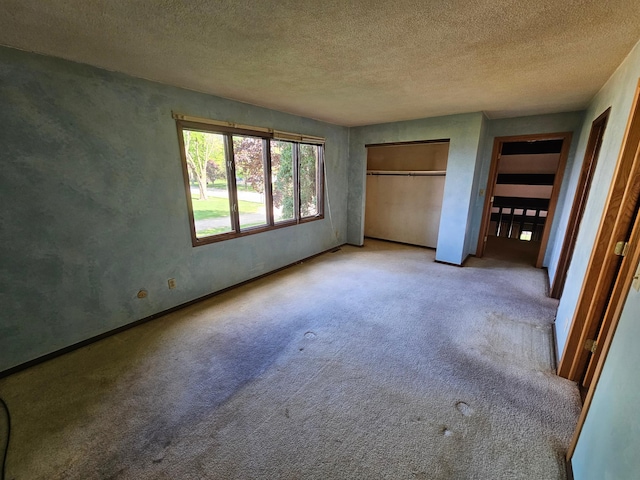 500 Lincoln St, Adams, MN 55909 - unfurnished bedroom featuring carpet flooring, a textured ceiling, baseboards, and a closet