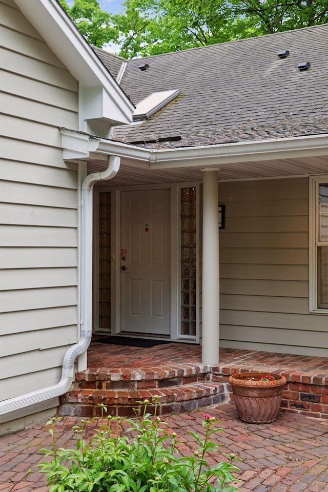 6 Shore Rd, North Oaks, MN 55127 - doorway to property with covered porch and roof with shingles