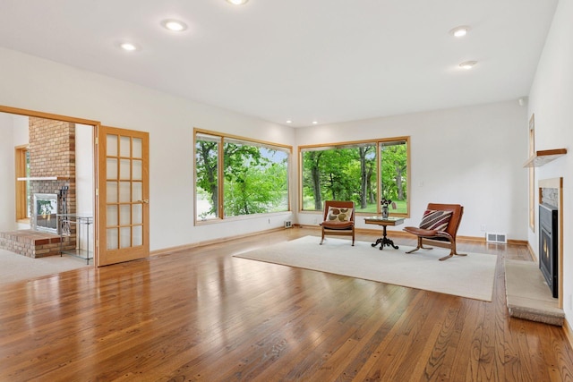 6 Shore Rd, North Oaks, MN 55127 - living area with a glass covered fireplace, wood finished floors, recessed lighting, and baseboards