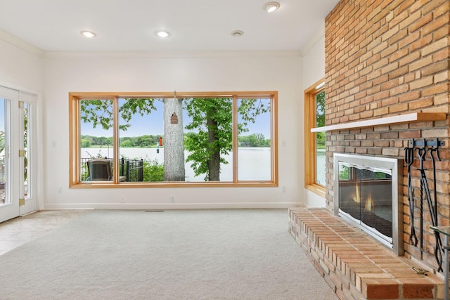 6 Shore Rd, North Oaks, MN 55127 - unfurnished living room with crown molding, a brick fireplace, baseboards, carpet flooring, and a water view