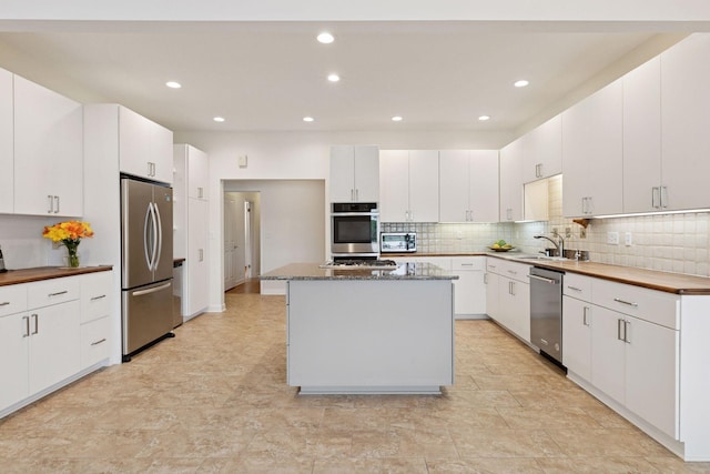 6 Shore Rd, North Oaks, MN 55127 - kitchen featuring appliances with stainless steel finishes, tasteful backsplash, recessed lighting, a center island, and white cabinetry