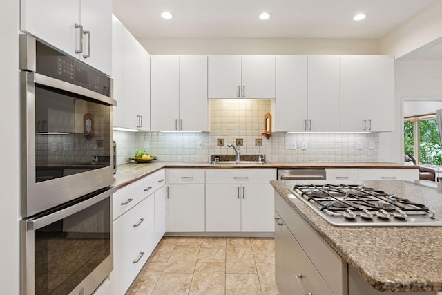 6 Shore Rd, North Oaks, MN 55127 - kitchen featuring appliances with stainless steel finishes, a sink, decorative backsplash, white cabinetry, and recessed lighting