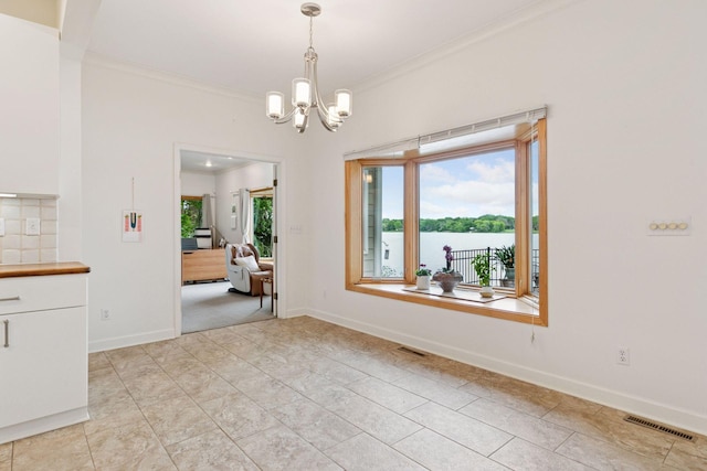 6 Shore Rd, North Oaks, MN 55127 - dining area featuring ornamental molding, a chandelier, baseboards, and a water view