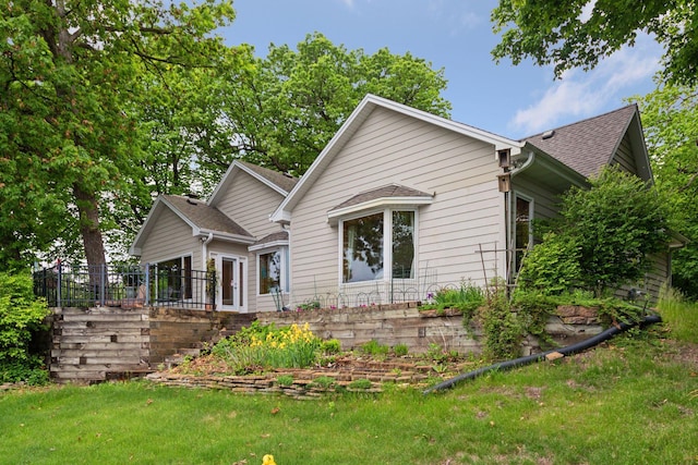 6 Shore Rd, North Oaks, MN 55127 - view of home's exterior with a shingled roof and a lawn
