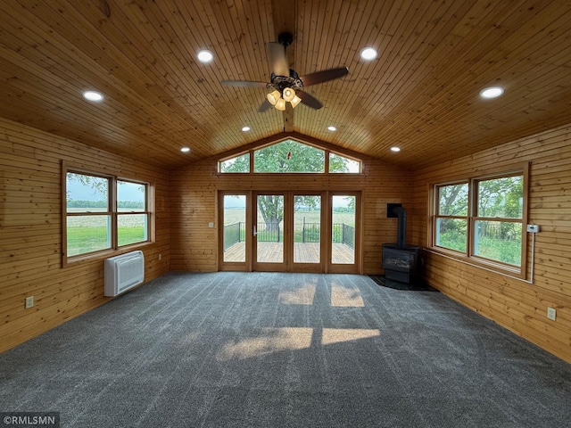 1616 130th Ave, Erin Prairie Twp, WI 54017 - unfurnished living room with a wood stove, a ceiling fan, carpet, vaulted ceiling, and plenty of natural light