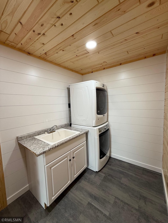 1616 130th Ave, Erin Prairie Twp, WI 54017 - laundry area with stacked washer / drying machine, wooden ceiling, wooden walls, dark wood finished floors, and baseboards