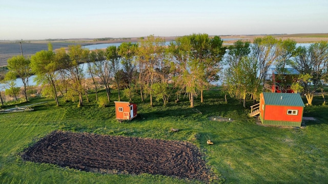 13739 429th Ave, Webster, SD 57274 - view of green lawn with an outbuilding, a water view, and a storage shed