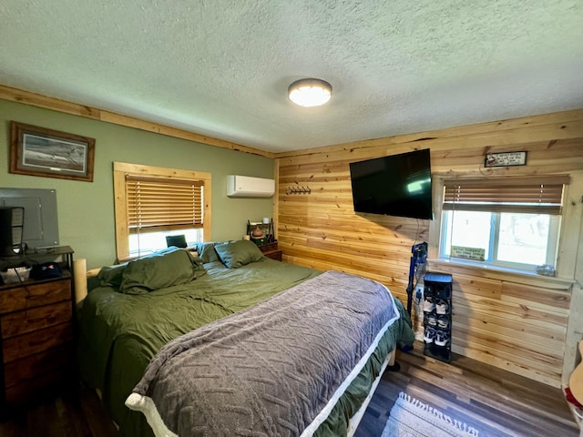 13739 429th Ave, Webster, SD 57274 - bedroom with a wall mounted air conditioner, wood finished floors, wooden walls, and a textured ceiling