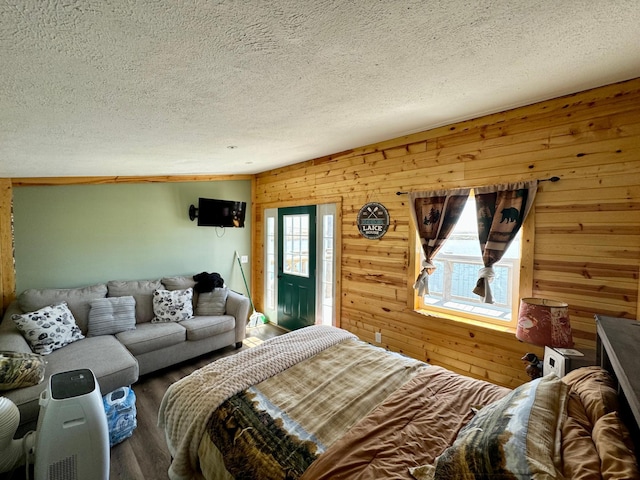 13739 429th Ave, Webster, SD 57274 - bedroom featuring wood walls, a textured ceiling, and wood finished floors