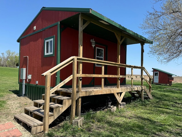 13739 429th Ave, Webster, SD 57274 - back of house with an outdoor structure, a lawn, and a deck