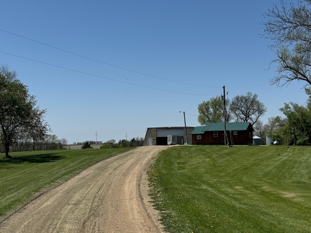 13739 429th Ave, Webster, SD 57274 - view of front of house featuring driveway, an attached garage, and a front lawn