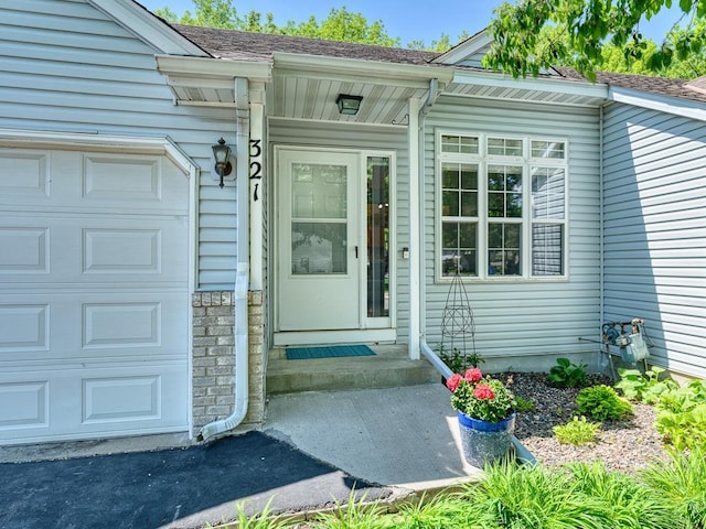 view of exterior entry with a garage