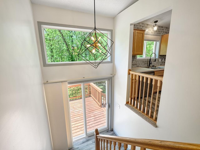 stairs featuring wood finished floors and a textured ceiling