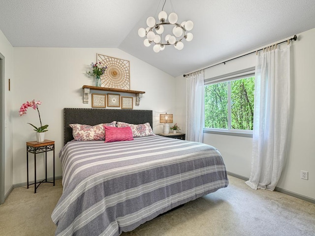 carpeted bedroom with a chandelier, vaulted ceiling, and baseboards