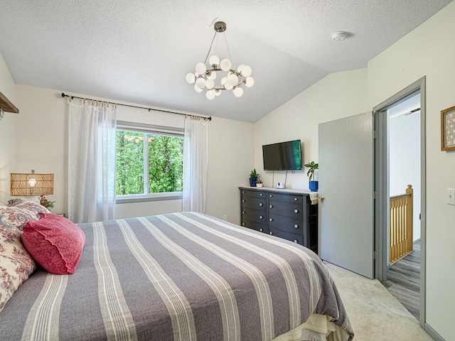 bedroom featuring vaulted ceiling, a chandelier, light colored carpet, and a textured ceiling