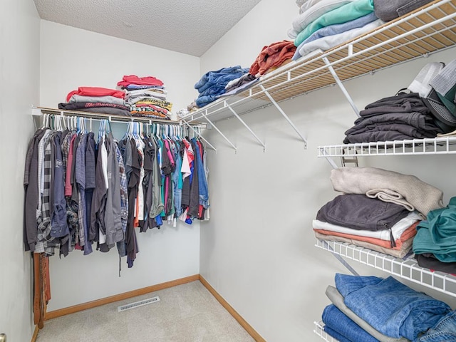 walk in closet featuring carpet