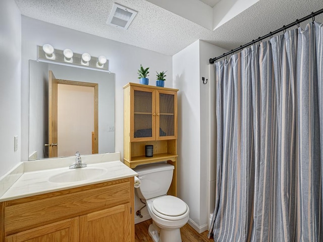 full bath featuring toilet, a textured ceiling, wood finished floors, vanity, and a shower with shower curtain