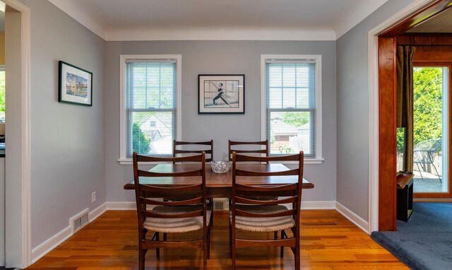 dining room with wood finished floors, baseboards, and plenty of natural light