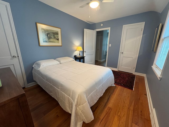 bedroom with wood finished floors, baseboards, and ceiling fan