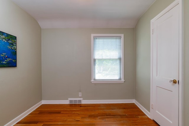 empty room with wood finished floors and baseboards