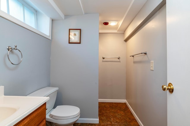 bathroom featuring vanity, toilet, and baseboards