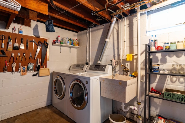 washroom with washer and dryer and concrete block wall