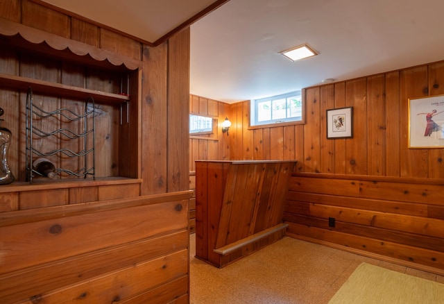 interior space with wooden walls and tile patterned floors