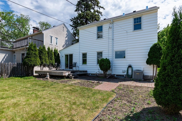 back of property with central AC and a wooden deck