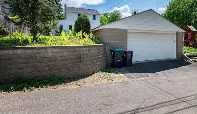 detached garage featuring fence