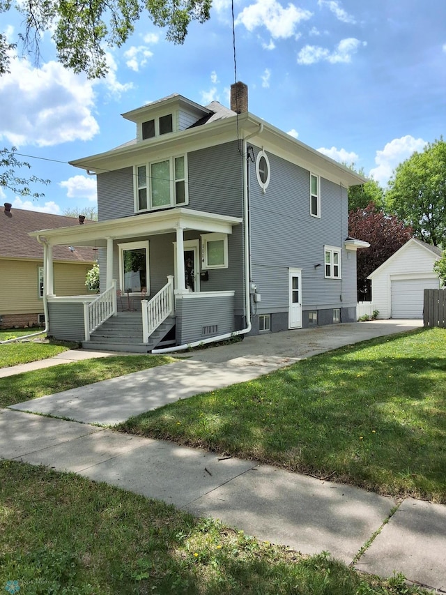 rear view of property featuring covered porch, a lawn, a chimney, an outdoor structure, and a garage