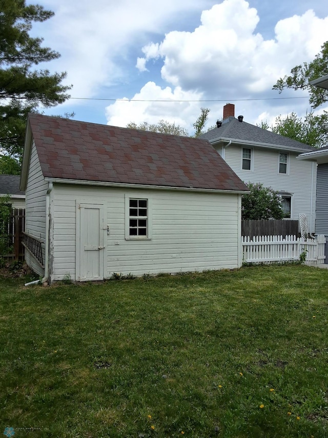 rear view of property featuring an outdoor structure