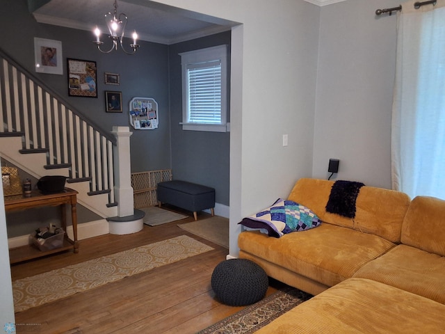 living area with wood finished floors, crown molding, stairs, a chandelier, and baseboards