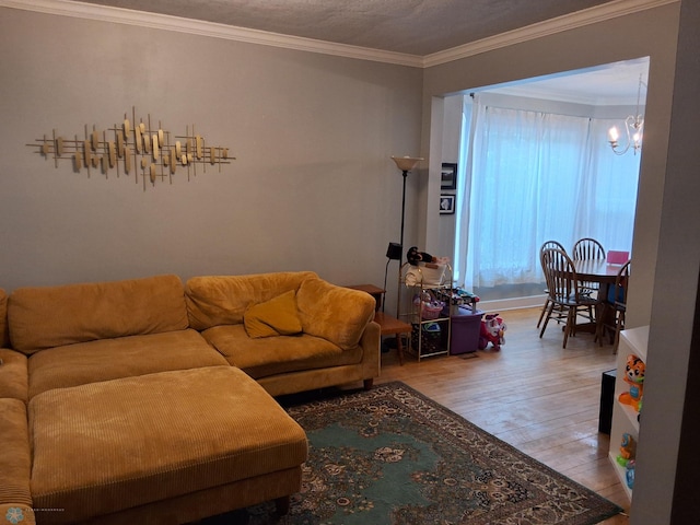 living room featuring wood finished floors, a chandelier, and ornamental molding