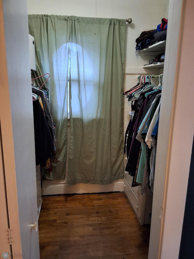 walk in closet featuring wood finished floors