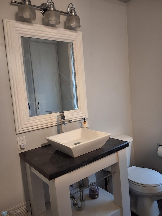 bathroom with toilet and vanity