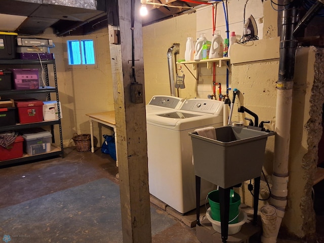 basement featuring separate washer and dryer and a sink