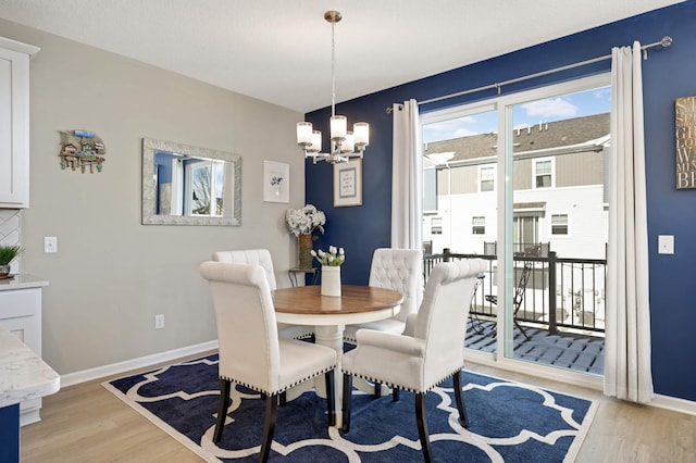 819 Roselyn Dr, Victoria, MN 55386 - dining room with light wood-style flooring, a chandelier, and baseboards