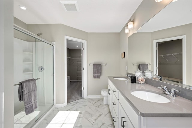 819 Roselyn Dr, Victoria, MN 55386 - bathroom with a walk in closet, double vanity, a stall shower, marble finish floors, and toilet