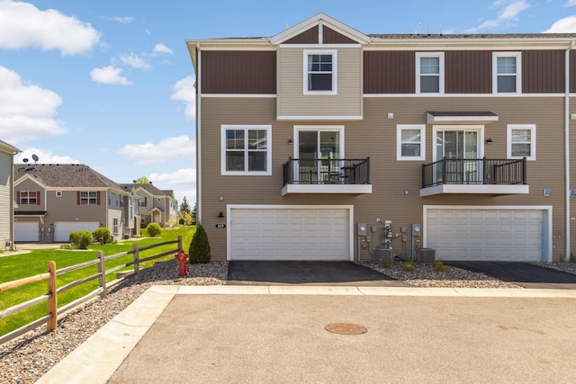 819 Roselyn Dr, Victoria, MN 55386 - townhome / multi-family property with an attached garage, asphalt driveway, and a residential view
