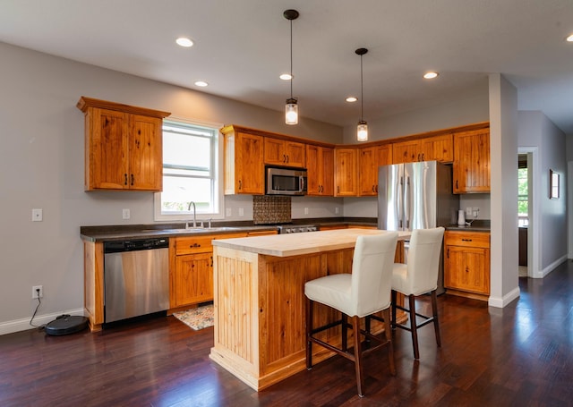721 Quail Pkwy, Watertown, MN 55388 - kitchen with appliances with stainless steel finishes, a sink, baseboards, recessed lighting, and a center island