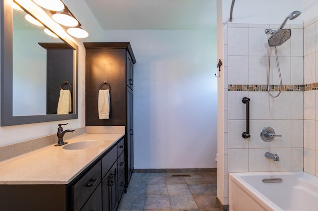 721 Quail Pkwy, Watertown, MN 55388 - bathroom featuring vanity, bathtub / shower combination, baseboards, and stone finish floors