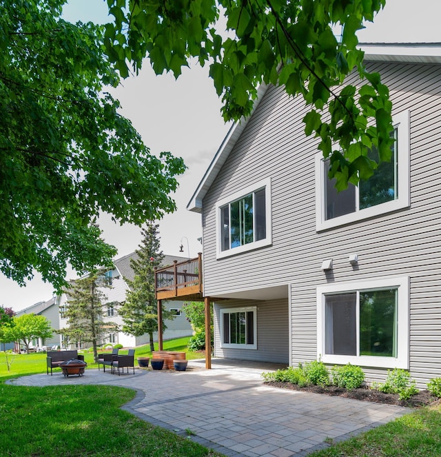 721 Quail Pkwy, Watertown, MN 55388 - back of property featuring a fire pit, a lawn, and a patio area